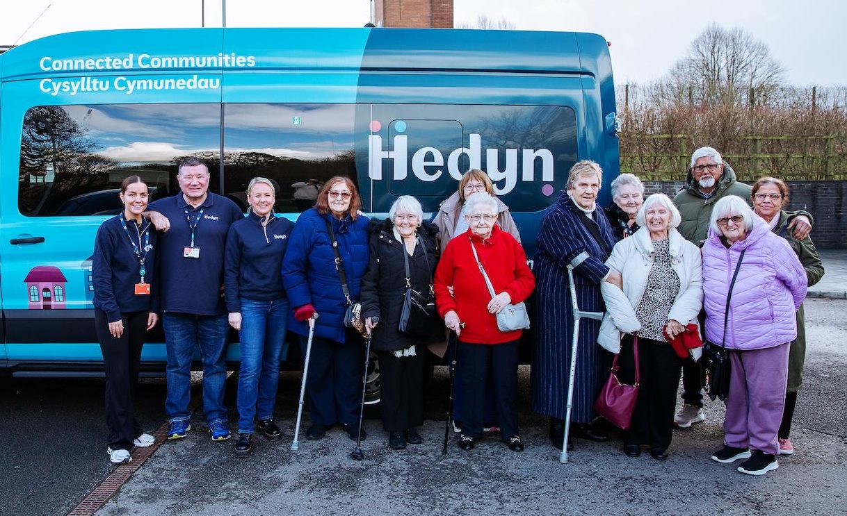 Hedyn colleagues and residents stand in front of the Hedyn bus.
