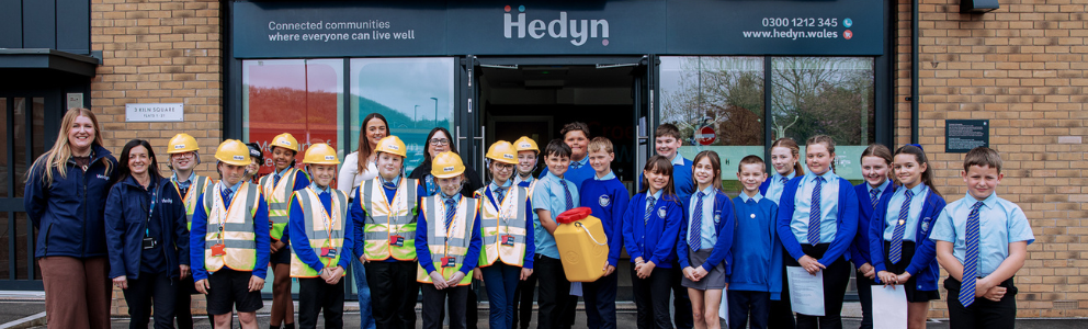 A group of school children outside of an office building