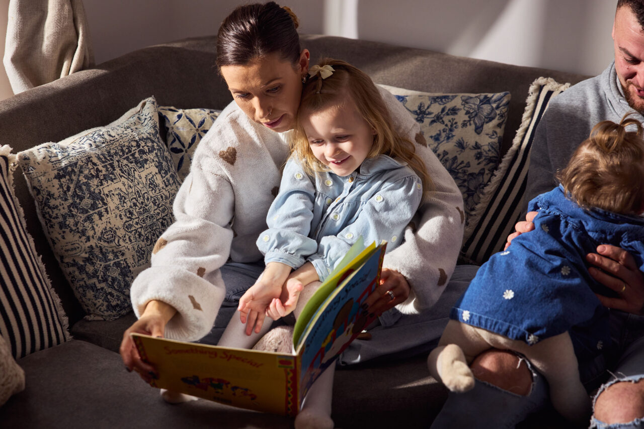 Photo of a mum and small child reading